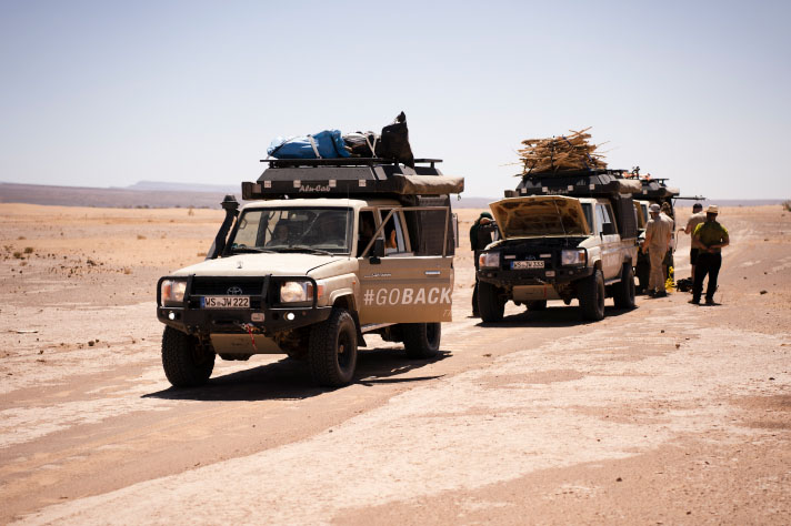 Two fully laden jeeps in the desert