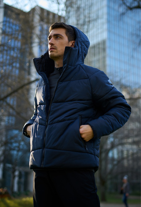 Man wearing a blue quilted jacket