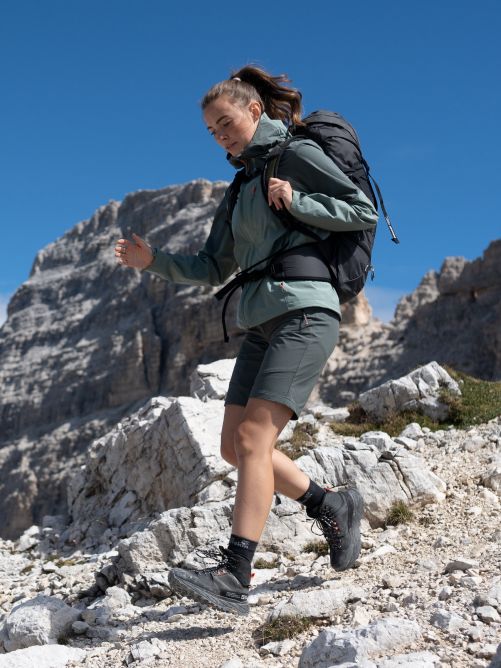 Hiker with a large pack walking down the mountain